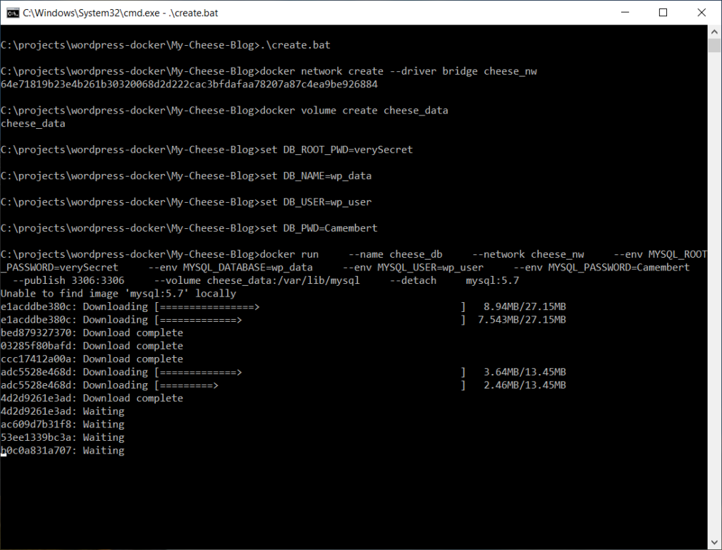 A screen shot of a Windows command shell while running create.bat showing Docker downloading MySQL image layers.